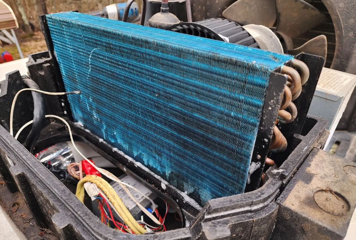 Stuart RV Repair technician servicing an RV air conditioning unit on-site in Martin County FL